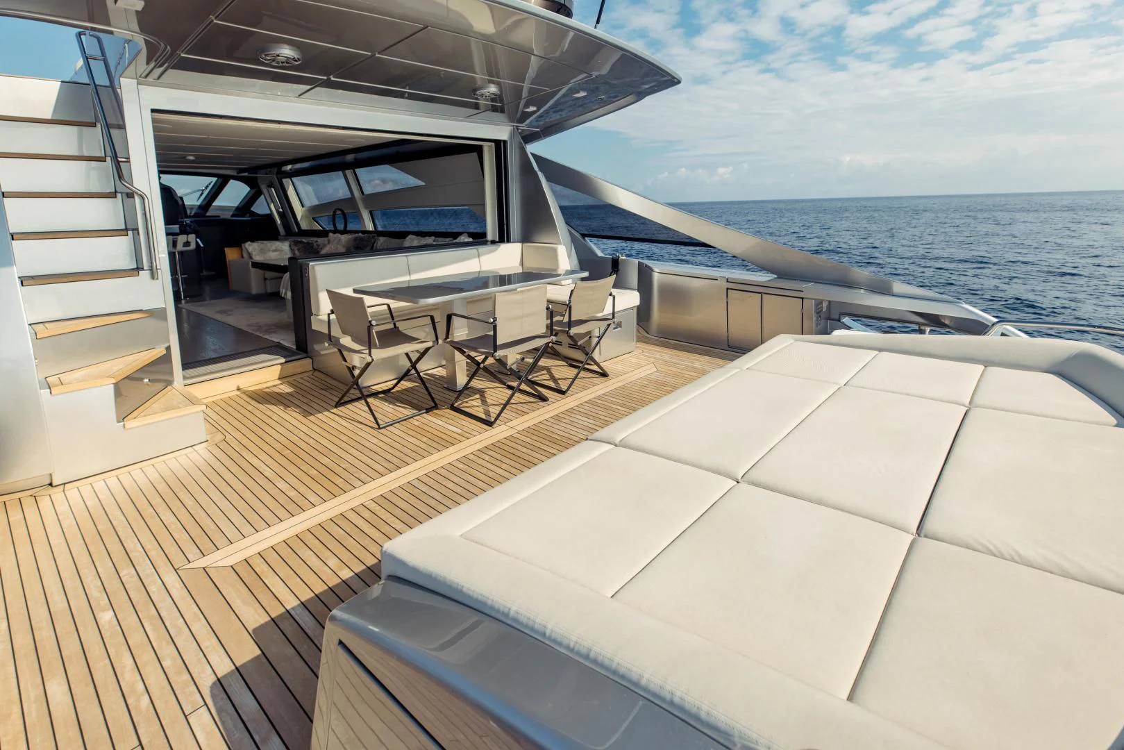 a deck with a boat and chairs on it aboard STALLION Yacht for Sale