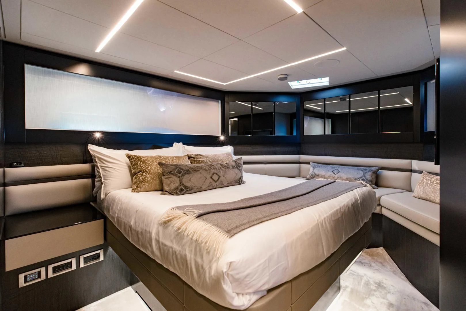 a room with a bed and a couch aboard STALLION Yacht for Sale