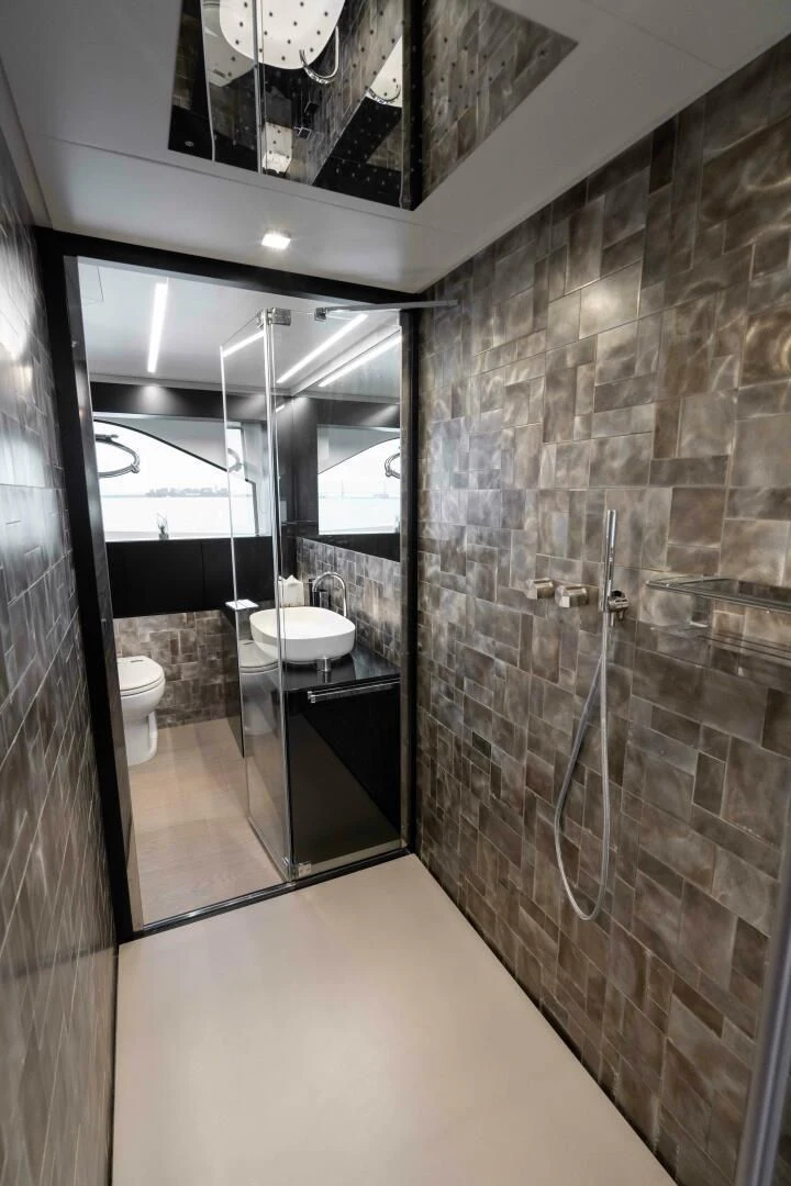a bathroom with a glass shower aboard STALLION Yacht for Sale