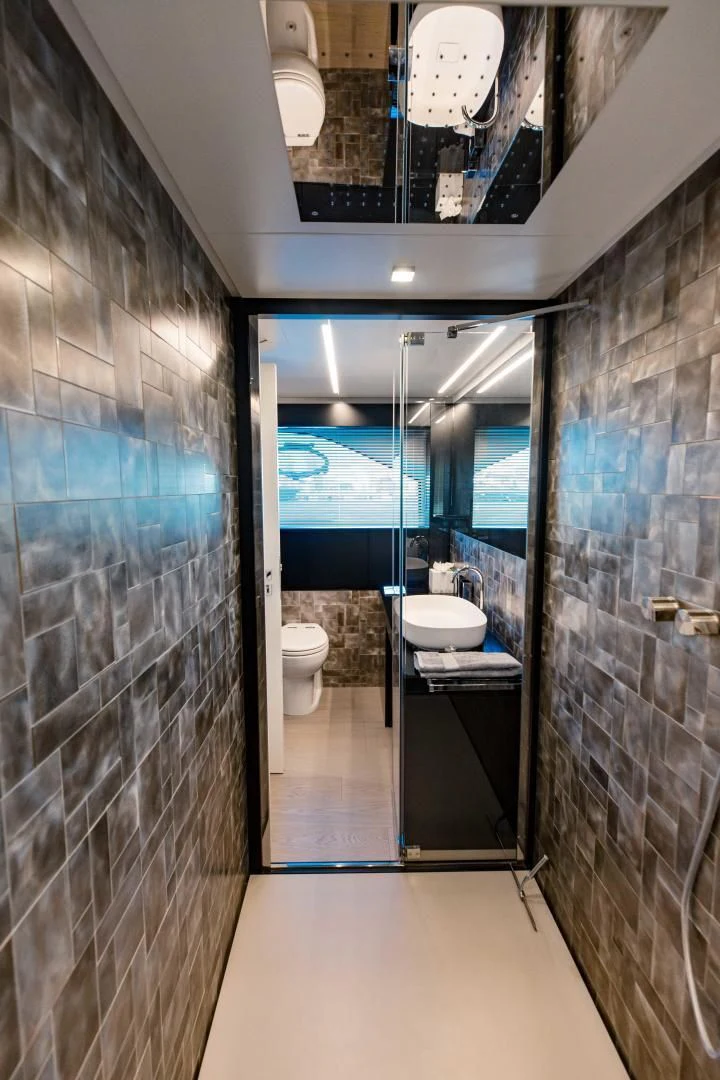 a bathroom with a glass shower aboard STALLION Yacht for Sale