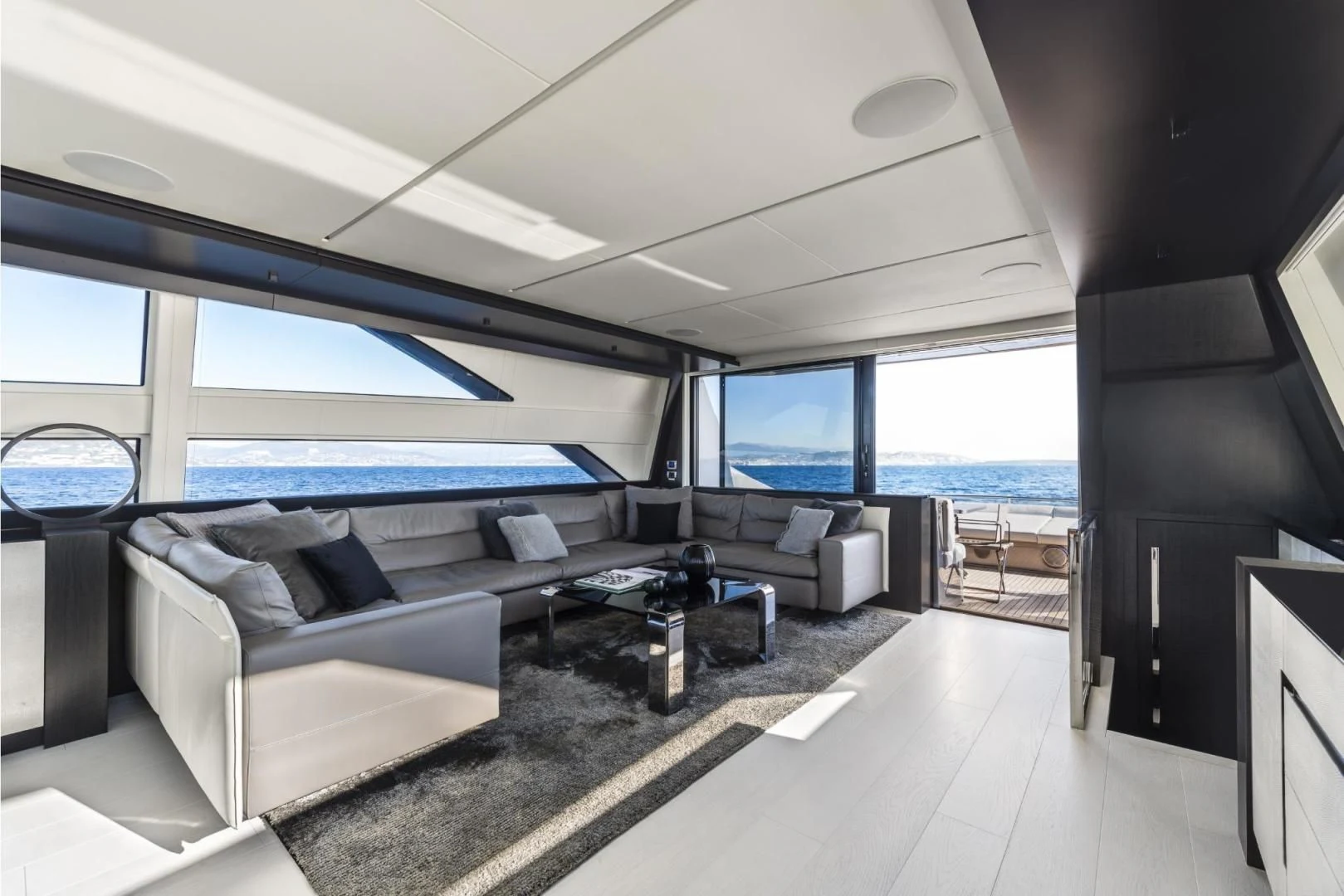 a room with a couch and a table and a window aboard STALLION Yacht for Sale