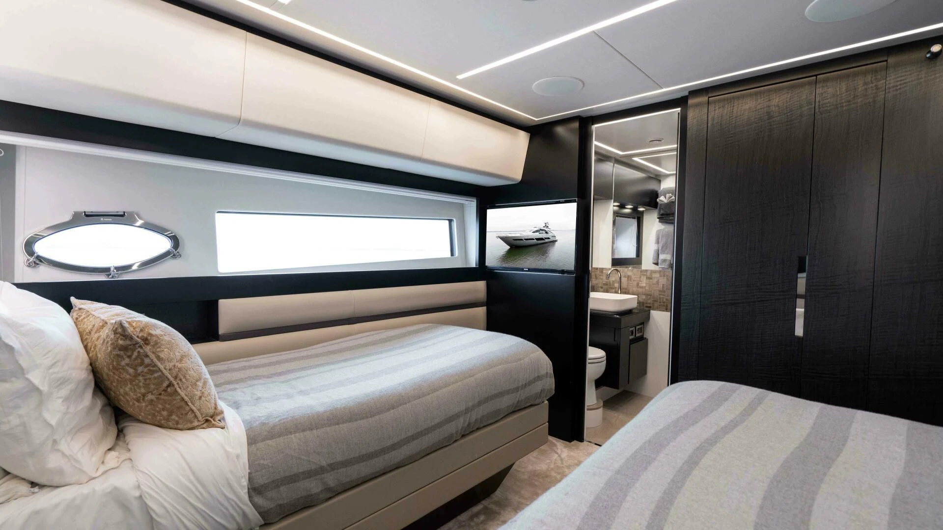 a room with a bed and a mirror aboard STALLION Yacht for Sale