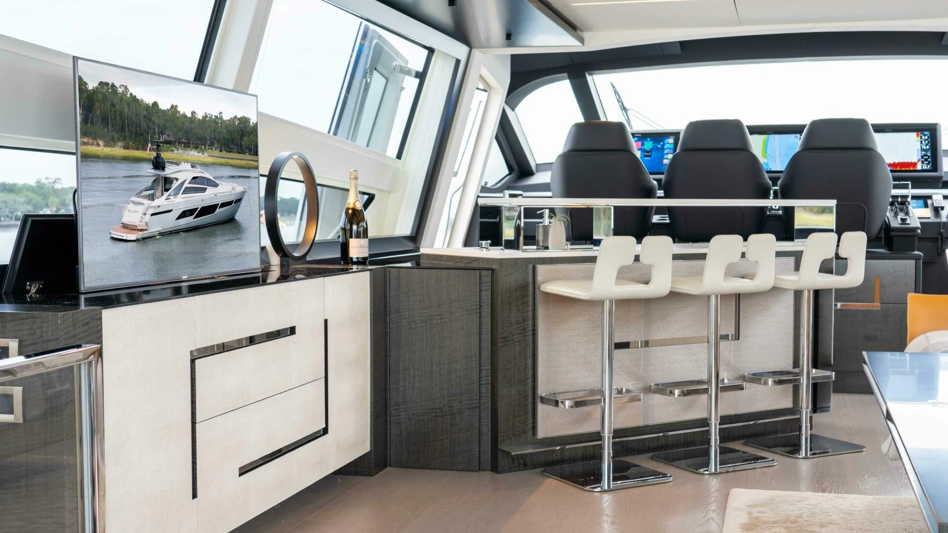 a room with a table chairs and a window with a view of the water aboard STALLION Yacht for Sale