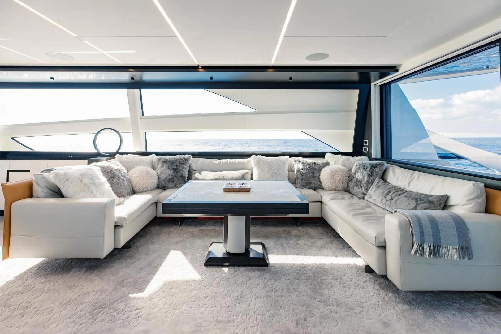 a living room with a couch and a table aboard STALLION Yacht for Sale