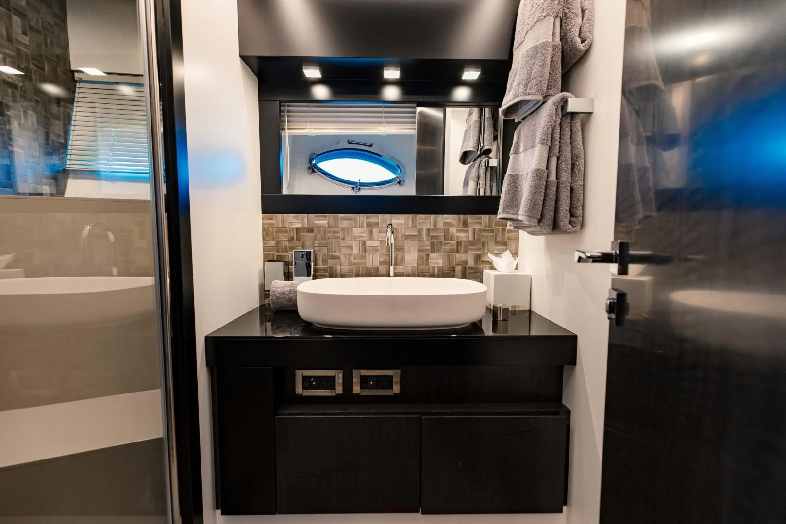 a bathroom with a sink and a mirror aboard STALLION Yacht for Sale