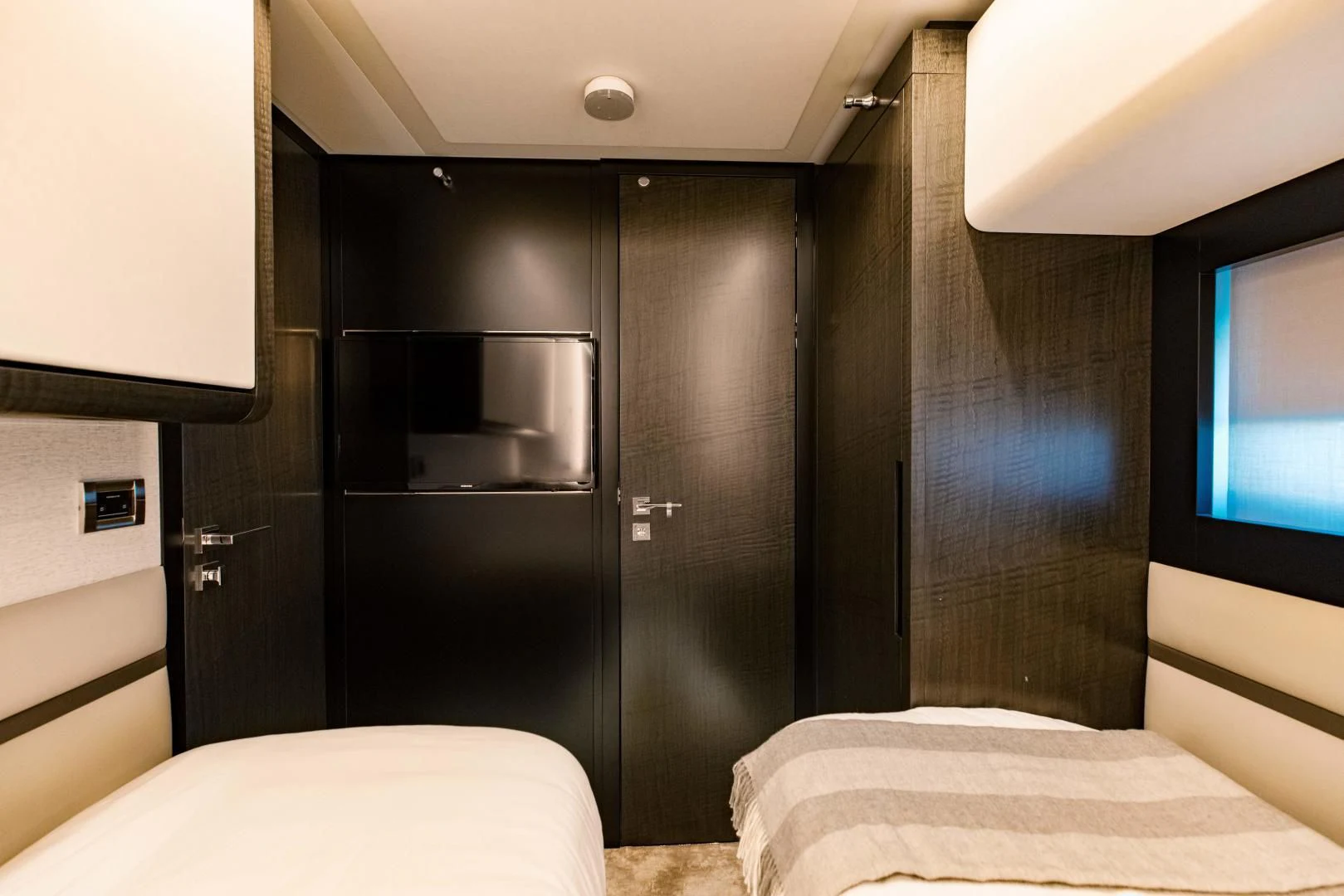 a room with a bed and a tv aboard STALLION Yacht for Sale