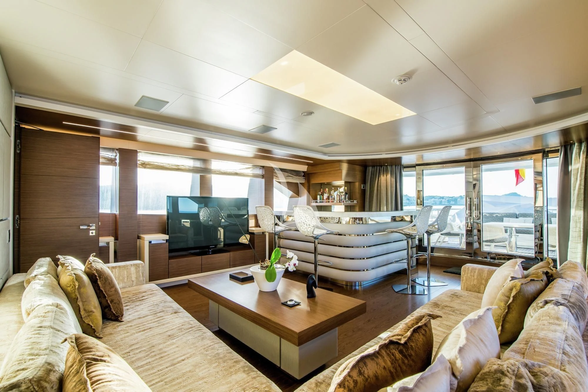 a living room with a large screen aboard AZIZA Yacht for Sale