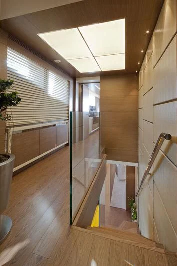 a hallway with a glass door aboard AZIZA Yacht for Sale