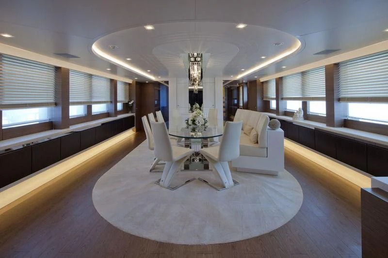 a large room with a large white oval table and chairs aboard AZIZA Yacht for Sale