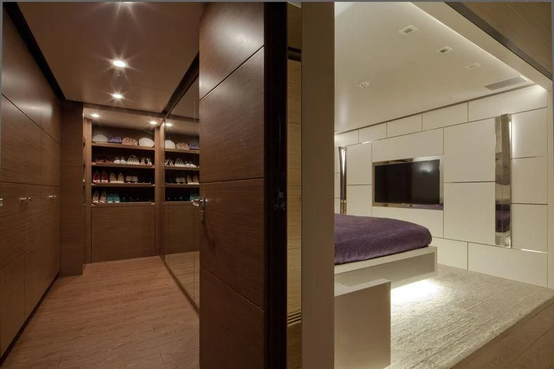 a room with a tv and a bed aboard AZIZA Yacht for Sale