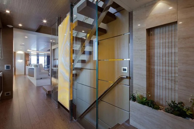 a room with a staircase and a large window aboard AZIZA Yacht for Sale