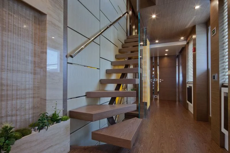 a room with wooden stairs aboard AZIZA Yacht for Sale