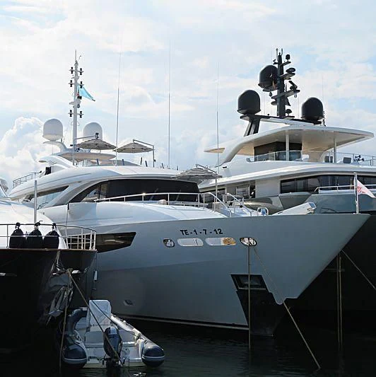 a white yacht docked aboard AZIZA Yacht for Sale