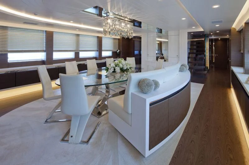 a room with a table and chairs aboard AZIZA Yacht for Sale