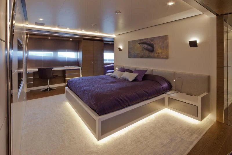 a large bed in a room aboard AZIZA Yacht for Sale
