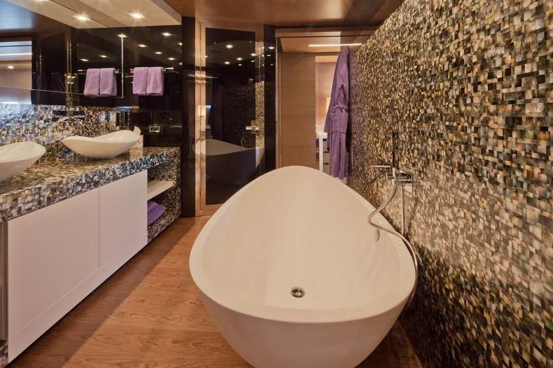 a bathroom with a large mirror aboard AZIZA Yacht for Sale