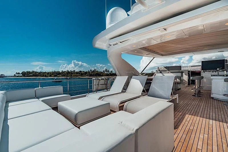 a large lounge area with a deck and a large pool aboard BLACKJACK Yacht for Sale