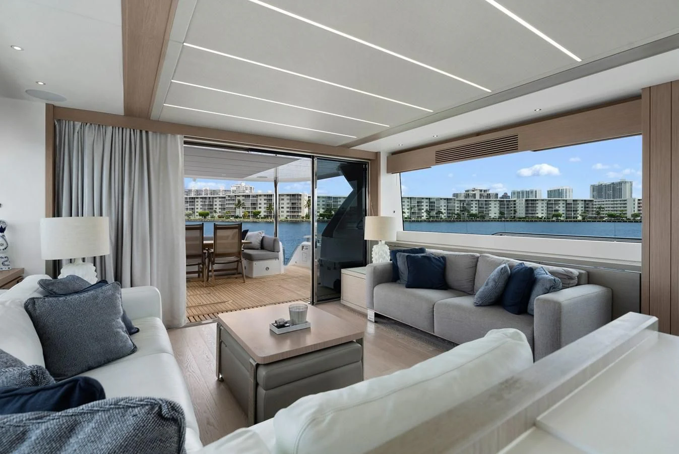 a living room with a large window aboard MILAMO Yacht for Sale