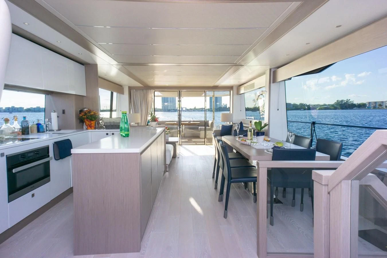 a kitchen with a table and chairs aboard MILAMO Yacht for Sale