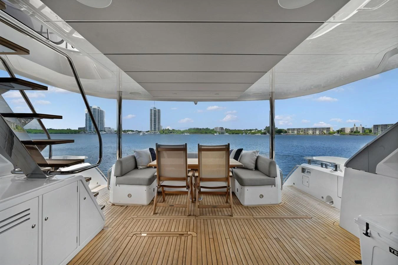 a room with a view of the water and a city aboard MILAMO Yacht for Sale