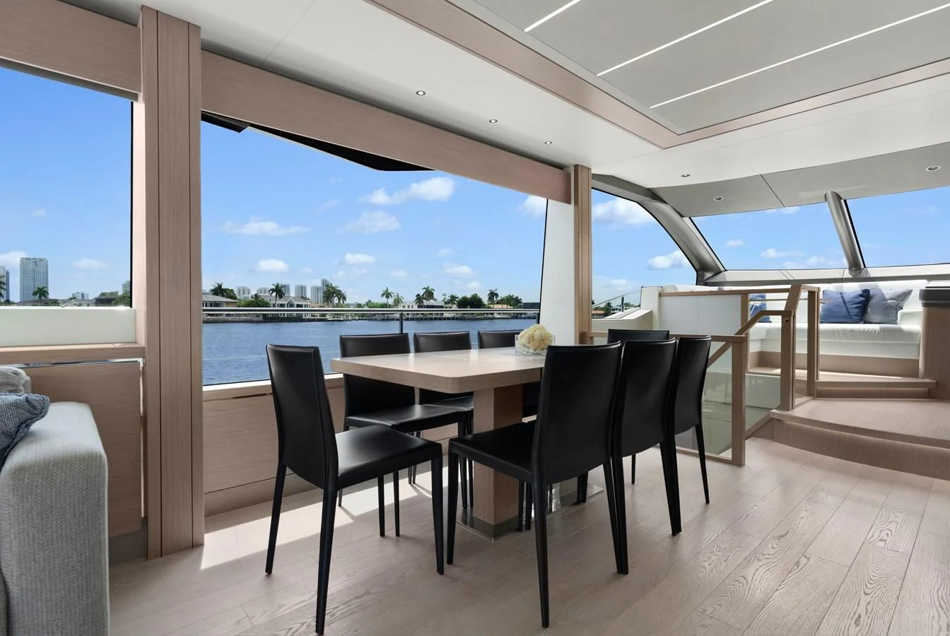 a table and chairs on a deck aboard MILAMO Yacht for Sale