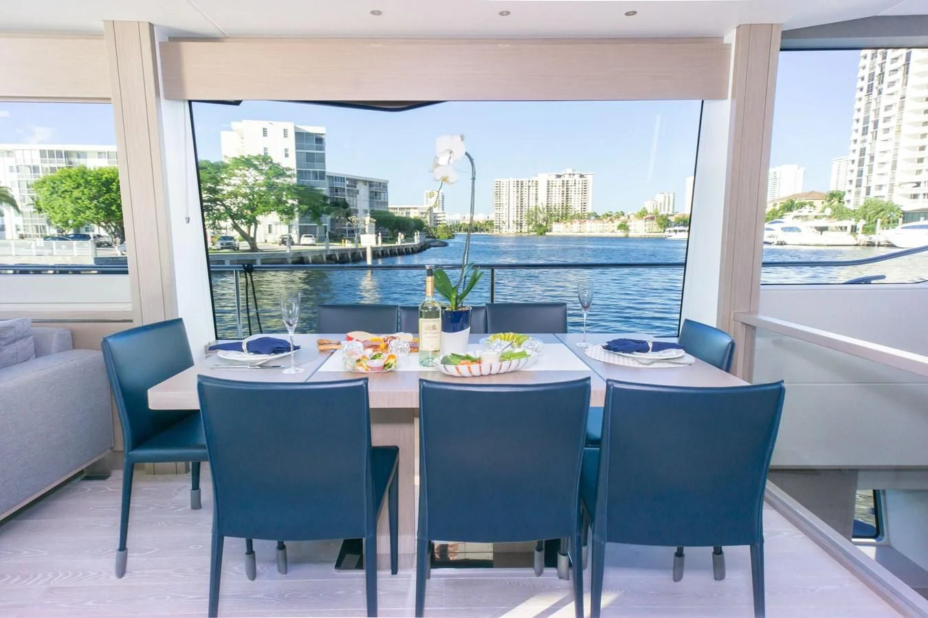 a table with chairs and a couch aboard MILAMO Yacht for Sale