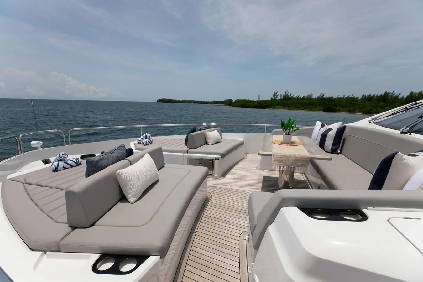 a deck with a view of the ocean and a beach aboard MILAMO Yacht for Sale