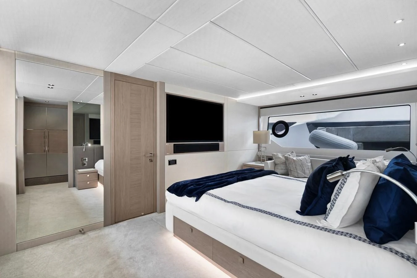 a room with a bed and a television aboard MILAMO Yacht for Sale