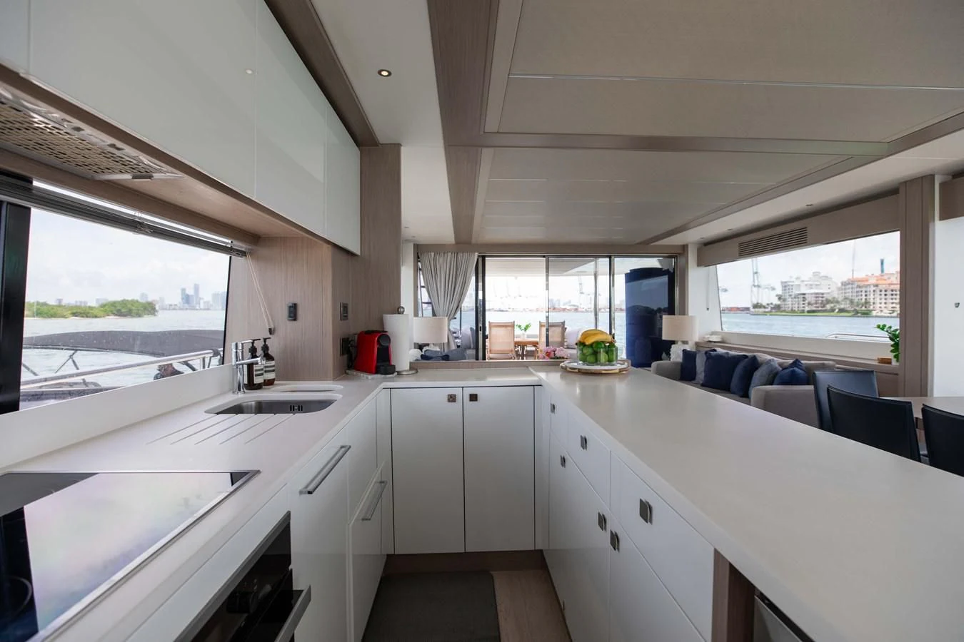 a kitchen with white cabinets aboard MILAMO Yacht for Sale