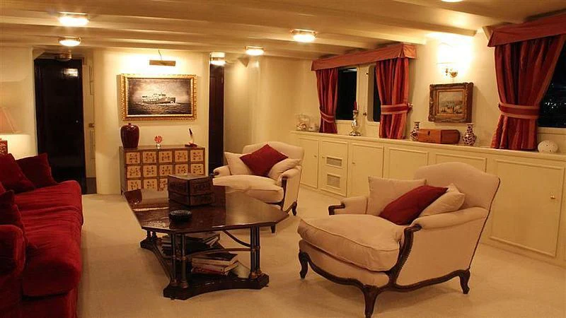 a living room with white furniture aboard D.P. MONITOR Yacht for Sale