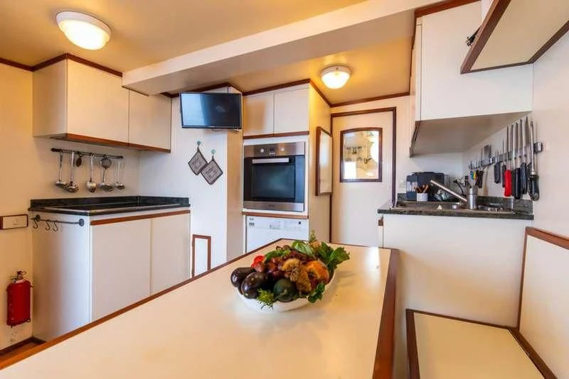 a kitchen with white cabinets aboard D.P. MONITOR Yacht for Sale