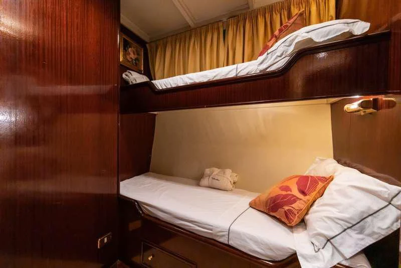 a room with a bed and a wood door aboard D.P. MONITOR Yacht for Sale
