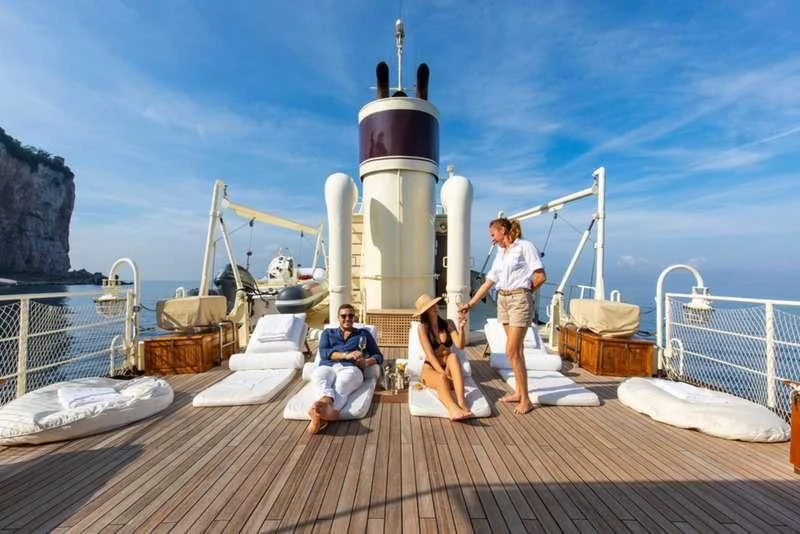 a group of people on a dock aboard D.P. MONITOR Yacht for Sale