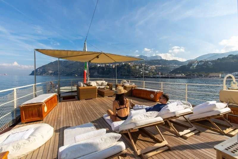 a group of people sitting on a boat on the water aboard D.P. MONITOR Yacht for Sale