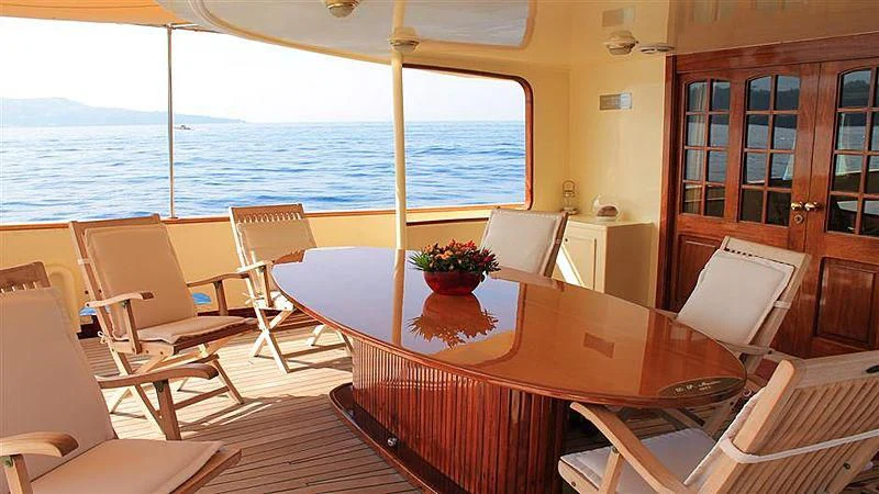 a room with a table and chairs aboard D.P. MONITOR Yacht for Sale