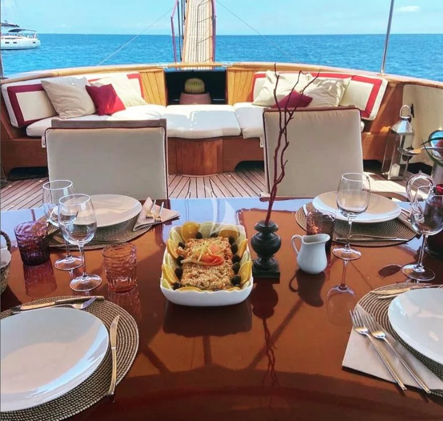 a table with plates and glasses on it aboard D.P. MONITOR Yacht for Sale