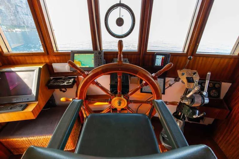 a room with a large wheel aboard D.P. MONITOR Yacht for Sale