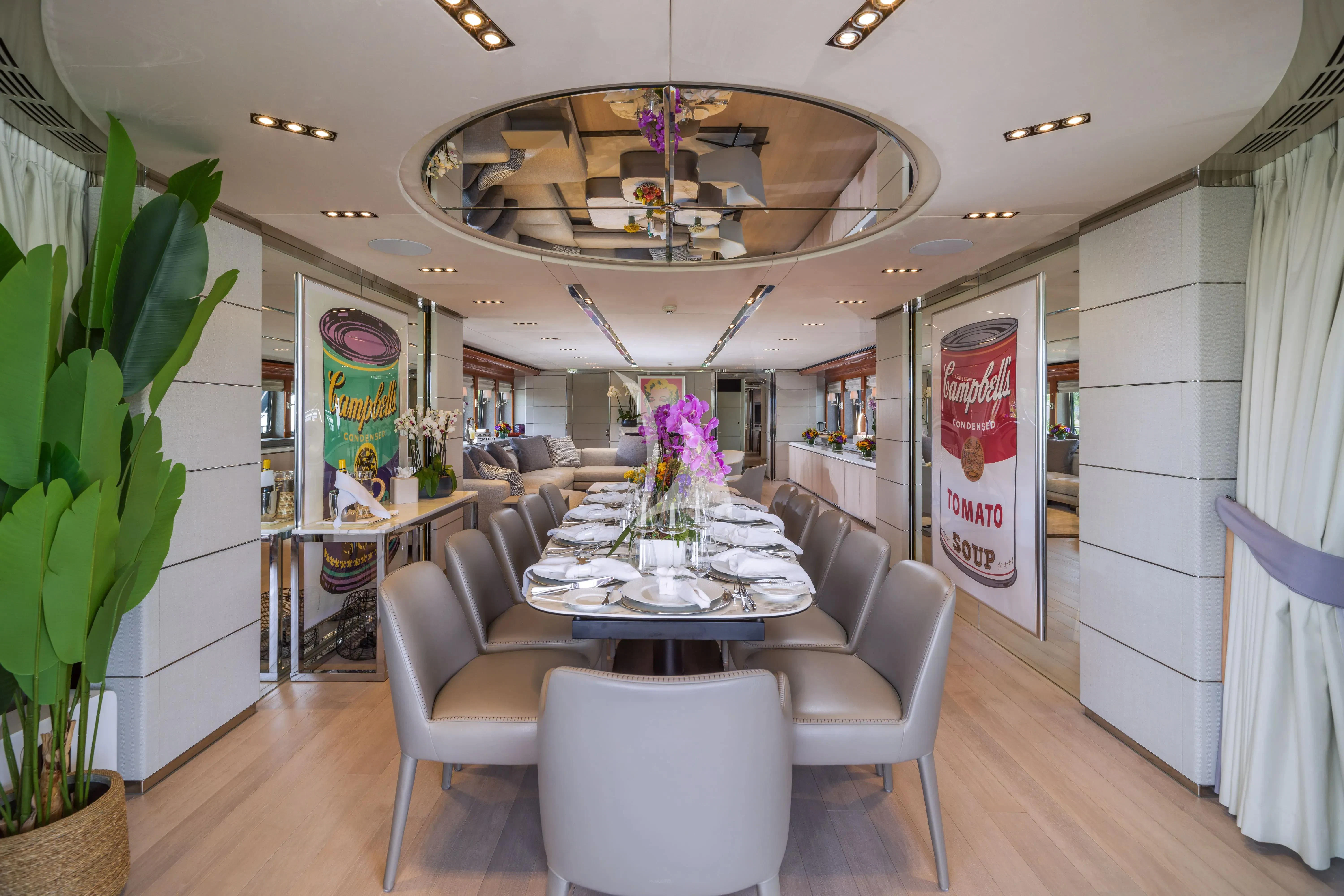 a dining room with a chandelier aboard BLISS Yacht for Sale