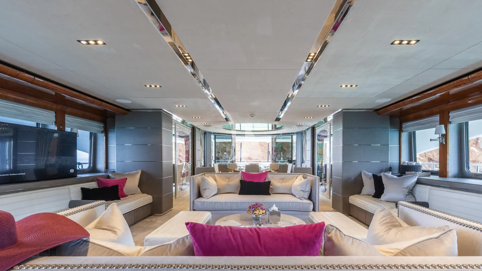 a living room with a large screen aboard BLISS Yacht for Sale
