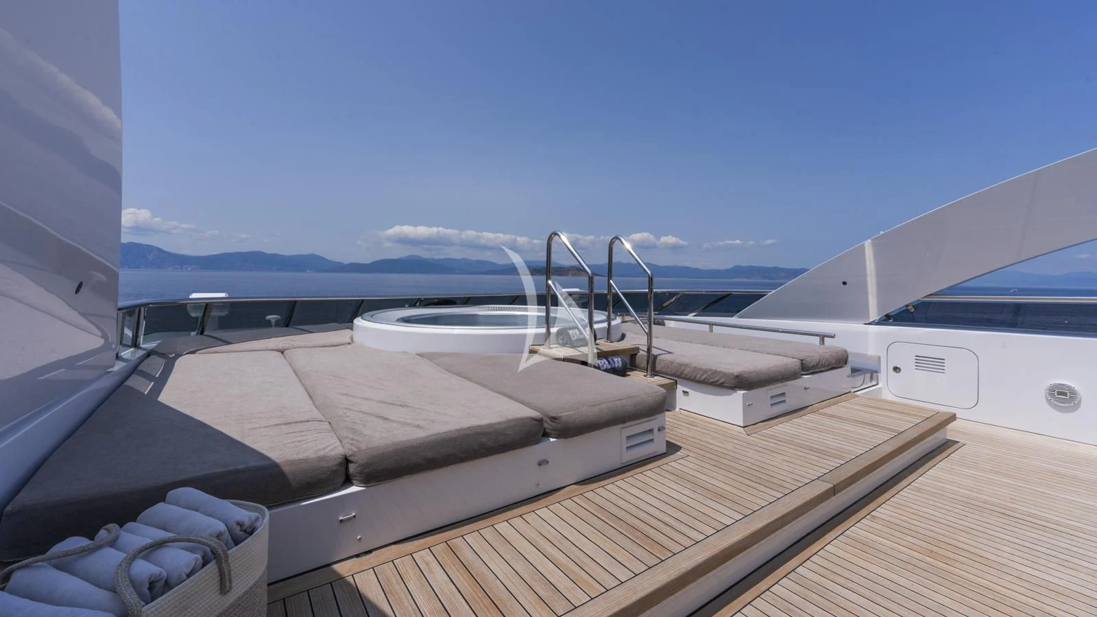 a deck with a boat and a view of the water aboard BLISS Yacht for Sale