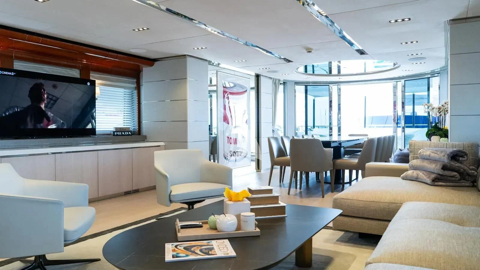 a living room with a large screen aboard BLISS Yacht for Sale