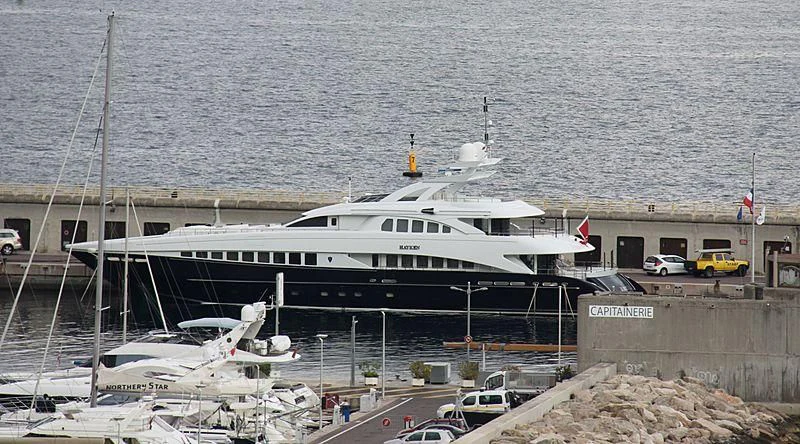 a large white boat docked at a pier aboard BLISS Yacht for Sale