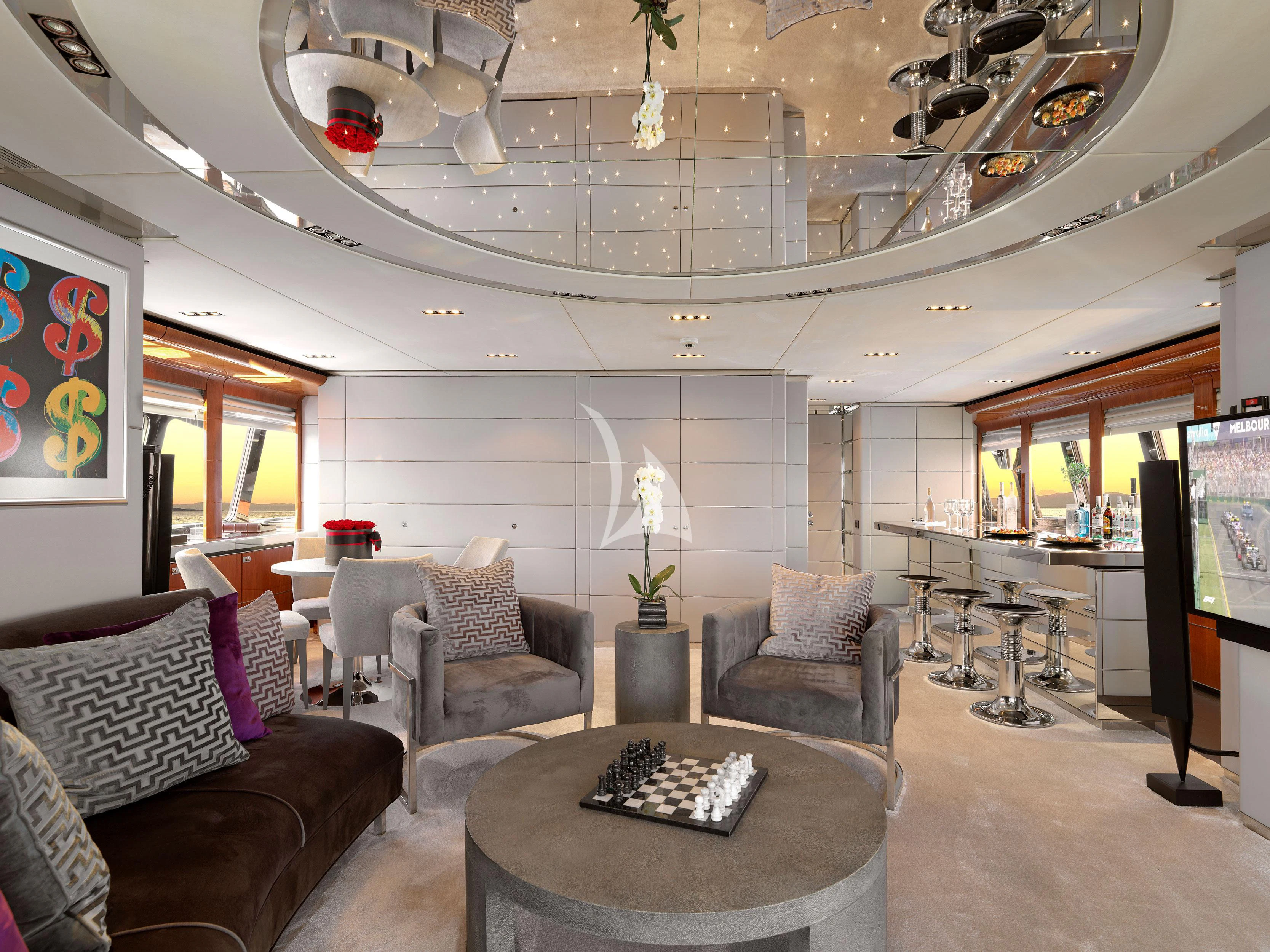 a living room with a chandelier aboard BLISS Yacht for Sale