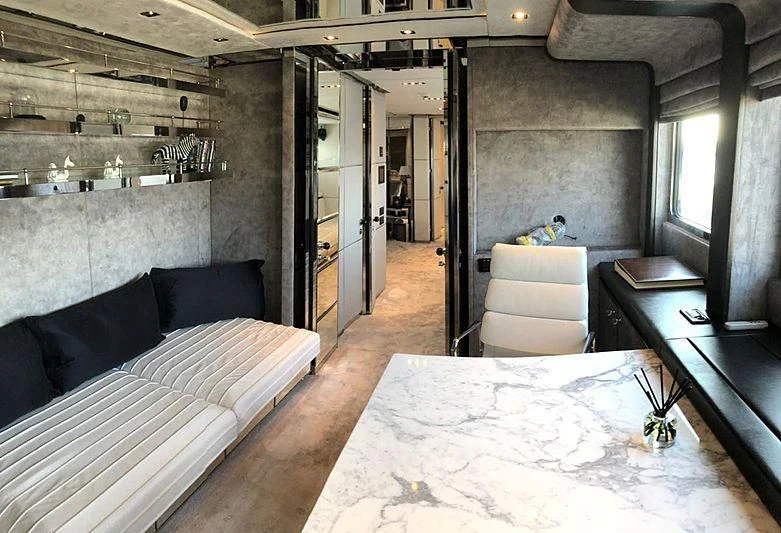 a room with a bed and a couch aboard BLISS Yacht for Sale