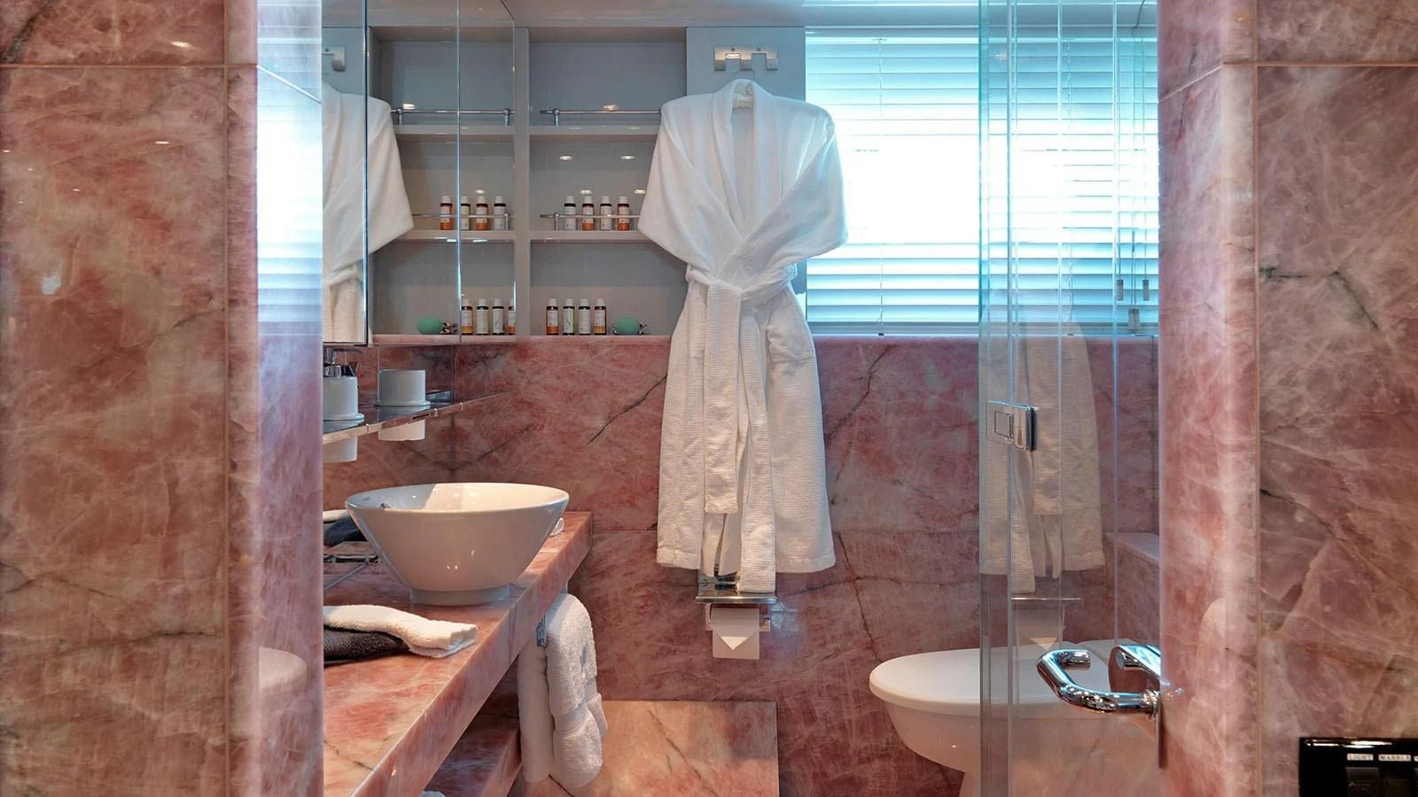a bathroom with a robe on the wall aboard BLISS Yacht for Sale