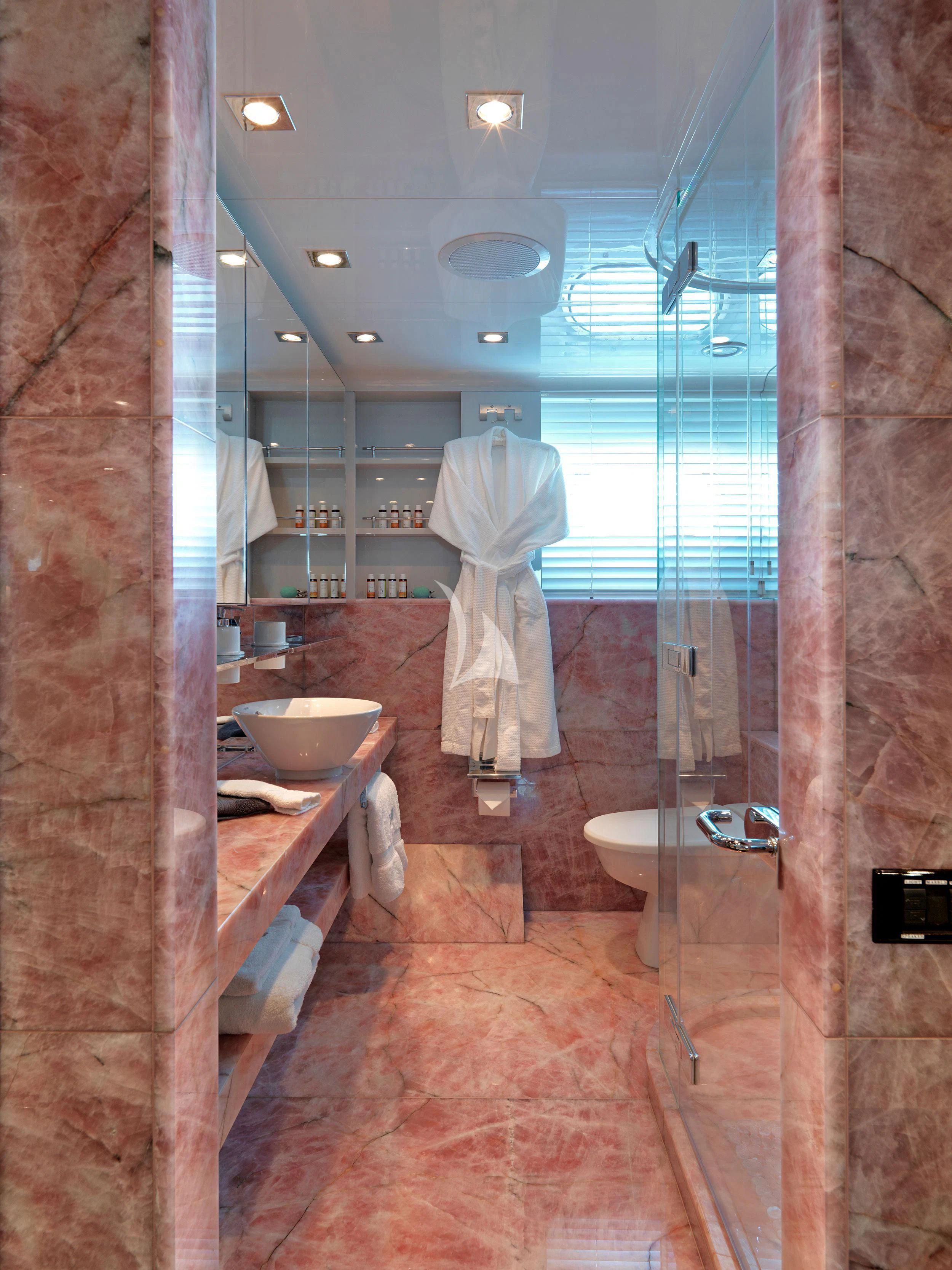 a bathroom with a robe on the wall aboard BLISS Yacht for Sale