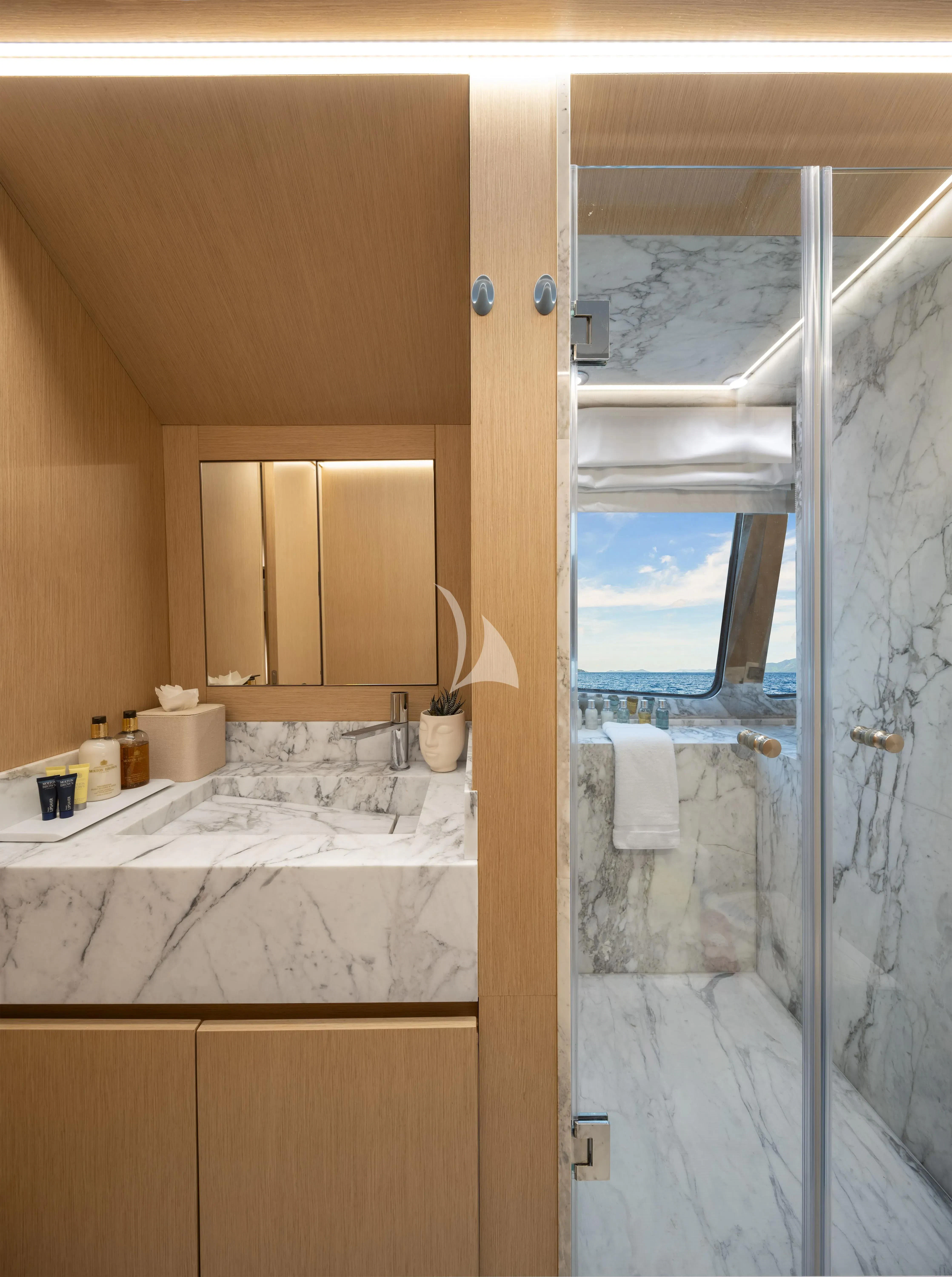 a bathroom with a glass shower aboard BLISS Yacht for Sale