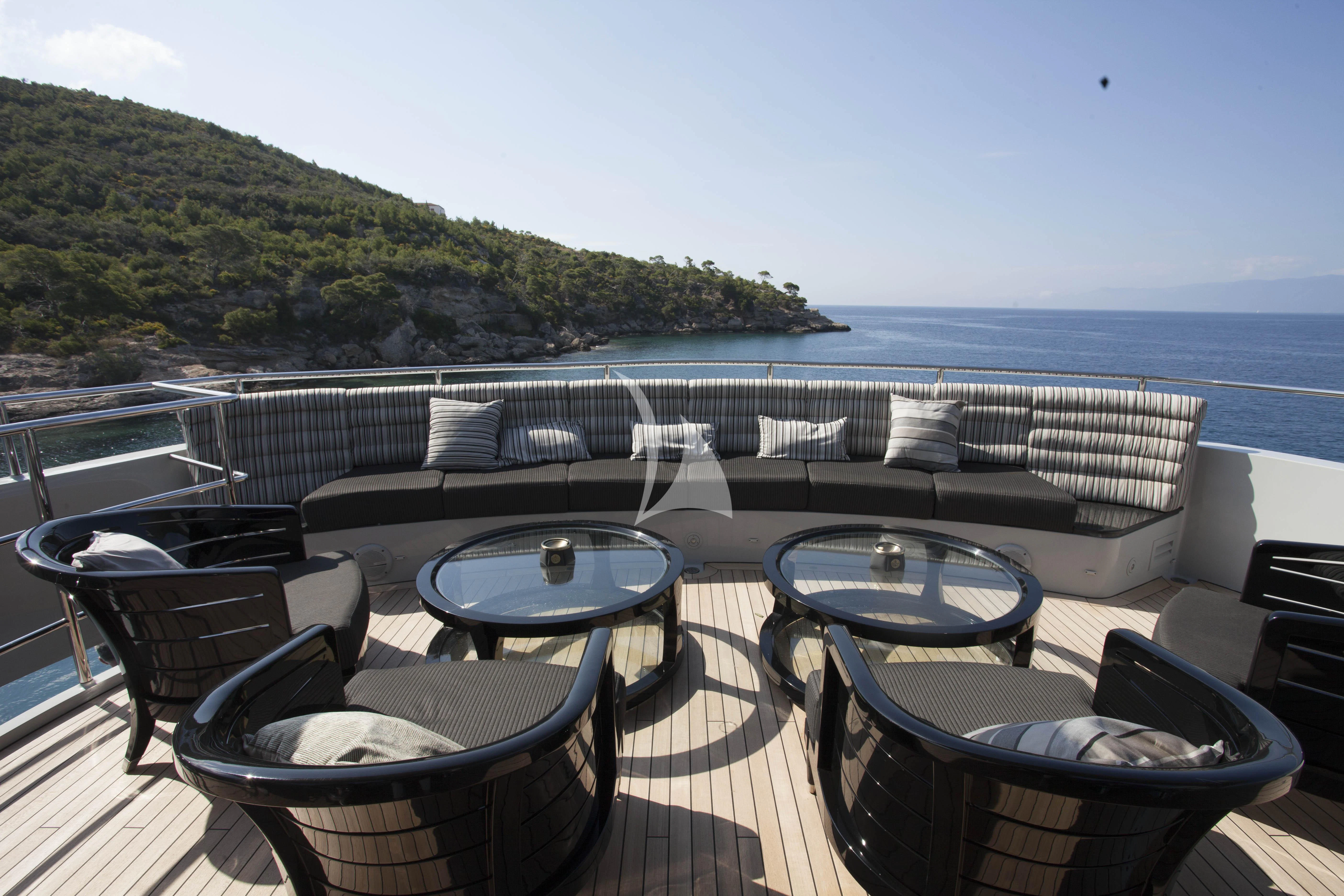 a patio with chairs and tables on it aboard BLISS Yacht for Sale