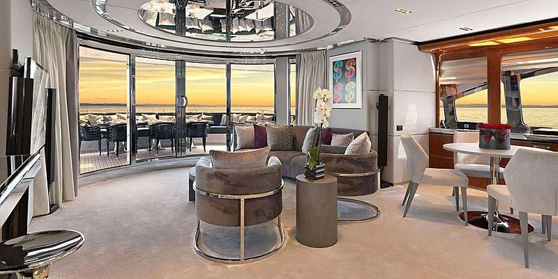 a living room with a couch and a coffee table aboard BLISS Yacht for Sale