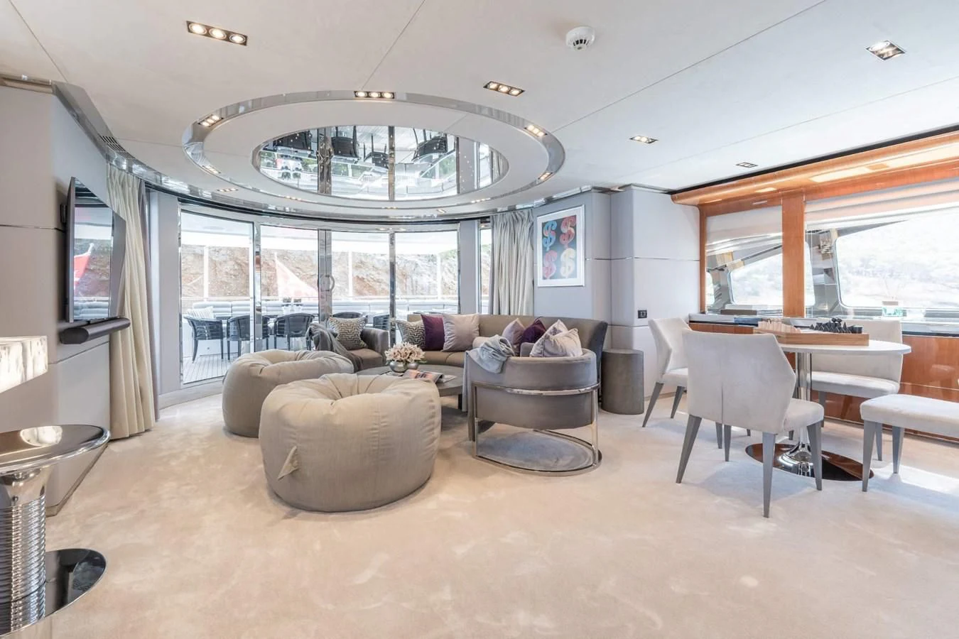 a living room with a large chandelier aboard BLISS Yacht for Sale
